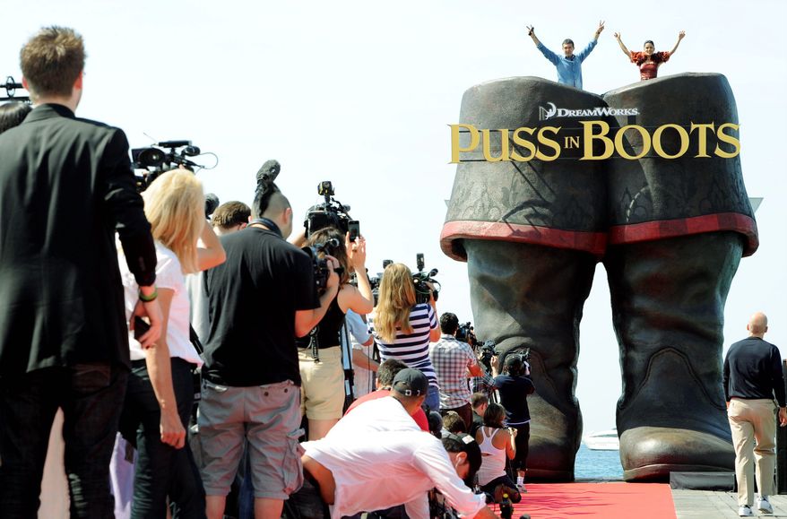 ASSOCIATED PRESS PHOTOGRAPHS
Mr. Banderas and Miss Hayek pose atop a giant pair of boots while promoting their new film, "Puss in Boots," at the Cannes Film Festival on Wednesday. DreamWorks showed off 15 minutes of the animated 3-D movie, a spin-off of the popular "Shrek" franchise.