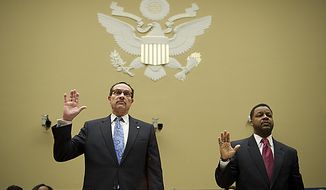 D.C. Mayor Vincent Gray (left) and City Council Chairman Kwame Brown are sworn in May 12 on Capitol Hill as they prepare to testify at a House Committee on Oversight and Government Reform subcommittee hearing on the city&#x27;s budget. (Rod Lamkey Jr./The Washington Times)
