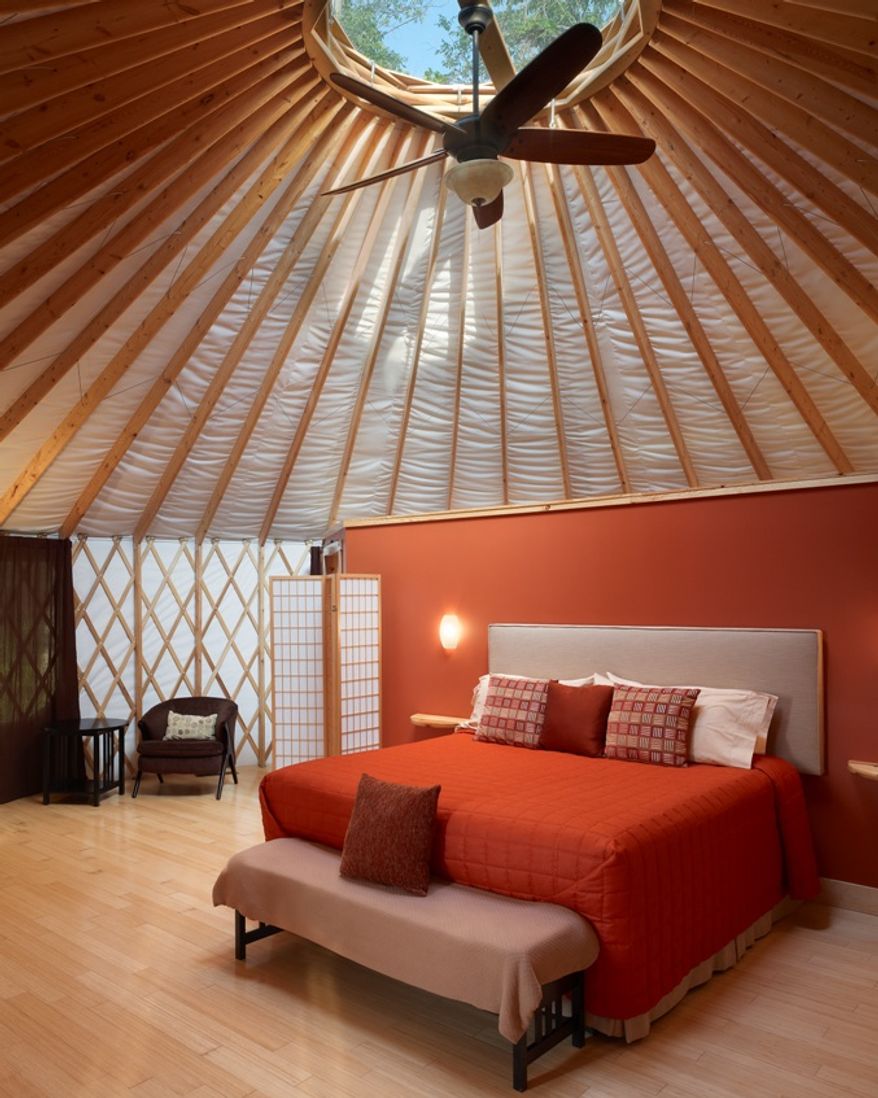 This July 2010 photo courtesy of the Wilds shows the luxurious grand yurt, which includes a king-size bed, bamboo flooring, en-suite bath as well as a private deck at Nomad Ridge at the Wilds, a sprawling eastern Ohio wildlife conservation center on nearly 10,000 acres, in Cumberland, Ohio. (AP Photo/the Wilds, B. Feinknopf)