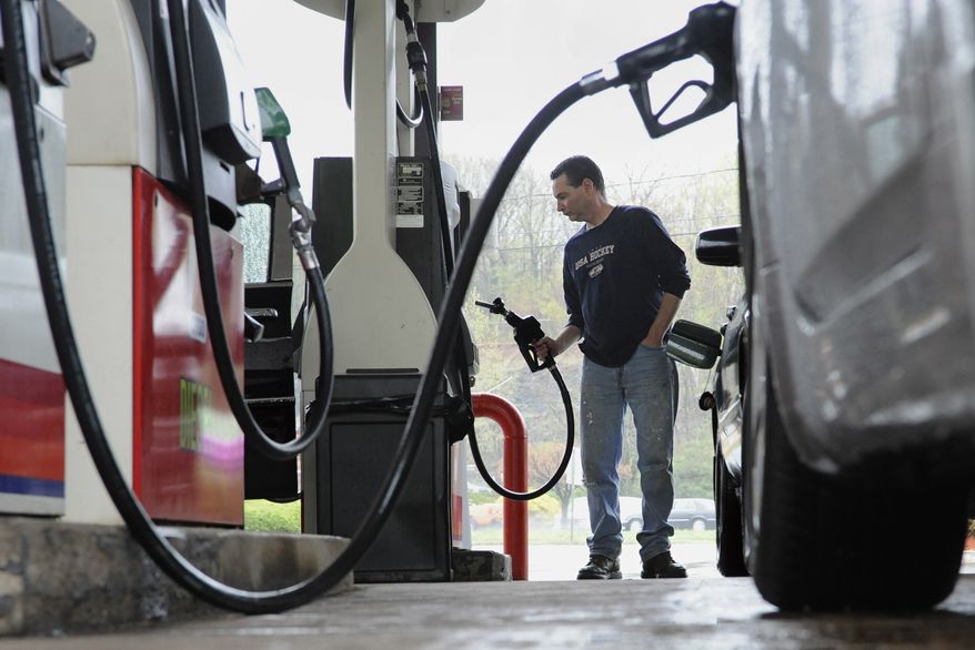 **FILE** John Magel, of Wetherfield, pumps gas April 28 at a station in Wethersfield, Conn. U.S. consumers paid more for gas and food in April, pushing inflation to its highest level in two and a half years. But so far in May 2011, inflationary pressures have begun to ease. (Associated Press)