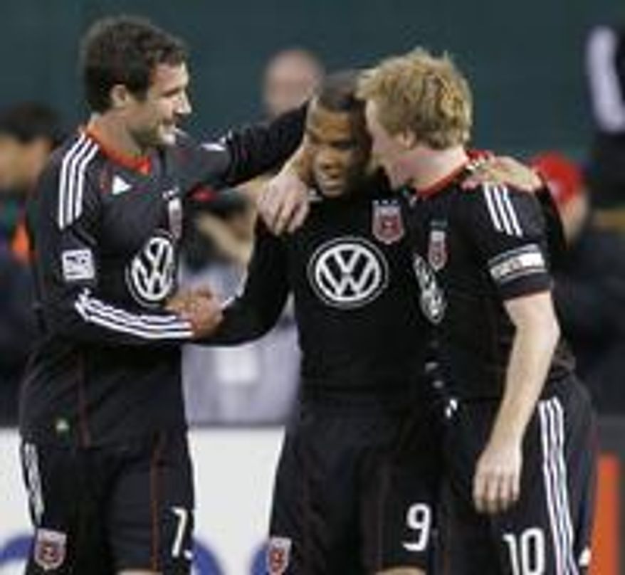 D.C. United's Chris Pontius (shown left) celebrating a goal against the Los Angeles Galaxy, with Charlie Davies (center) and Dax McCarty (right). (Associated Press)