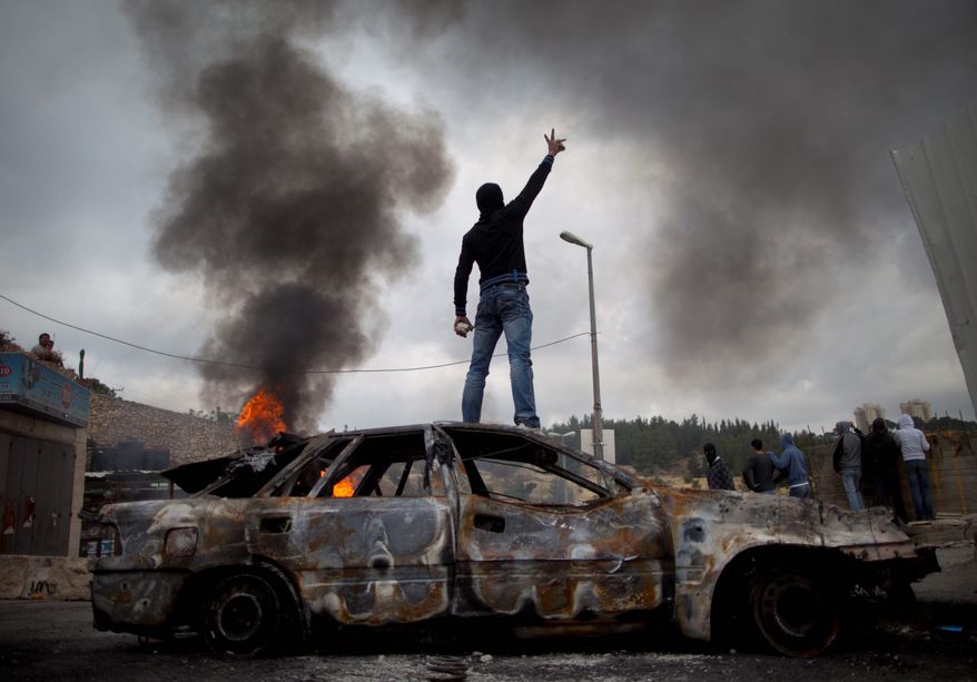 ASSOCIATED PRESS
HEATING UP: A Palestinian takes a stand during clashes with Israeli troops. Demonstrators were marking the 63rd anniversary of Israel's founding in 1948, what they call "al-Naqbah," or "the Catastrophe."