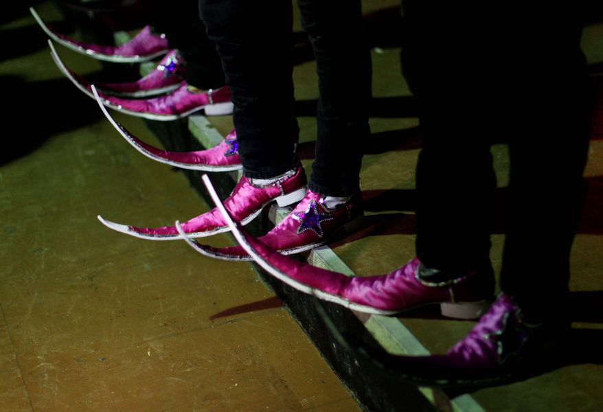 Members of the "Parranderos" dance crew wait for a competition to begin at the Mesquit Rodeo nightclub. Dance crews were the first to embrace the pointy-toed boots, which many decorate glitteringly.