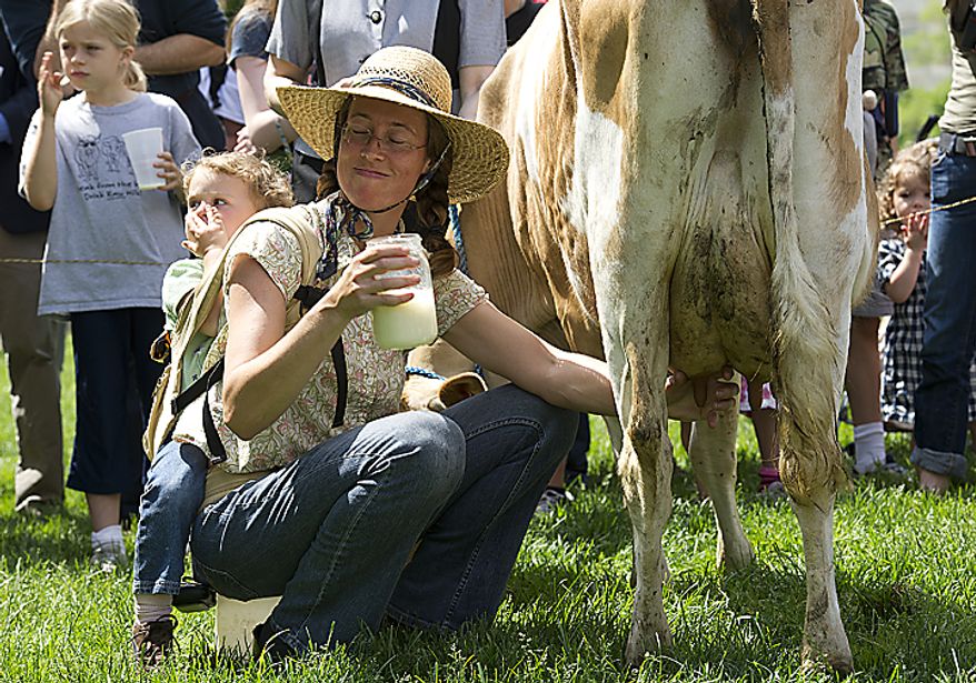 Leah Mack of Union Bridge, Md., holds a jar of milk she just got from Morgan the cow at a rally held by the organization Grassfed on the Hill at Upper Senate Park in Washington, D.C., on Monday, May 16, 2011. Fresh milk drinkers and advocates came out to protest the sting operation the FDA conducted against Pennsylvania dairy farmer Dann Allgyer and his private buying customers. (Barbara L. Salisbury/The Washington Times)
