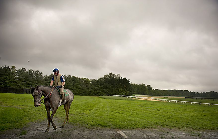 Rider Phil Judge takes a horse back into the stables after going around the track for a few laps at Chanceland Farms in West Friendship, Md., Tuesday, May 17, 2011. (Rod Lamkey Jr./The Washington Times)