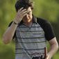 This April 10, 2011, file photo shows Rory McIlroy wiping his forehead after his final round of the Masters golf tournament, in Augusta, Ga. With the Masters meltdown firmly behind him, a reinvigorated Rory McIlroy intends to adopt a bullish approach as he bids to win his first tournament in 2011. The 21-year-old Northern Irishman went into the final round at Augusta National last month with a four-stroke lead, but hopes of landing his first major were dashed after shooting an 8-over 80 in a dramatic collapse to drop to 15th. (AP Photo/David J. Phillip, File)