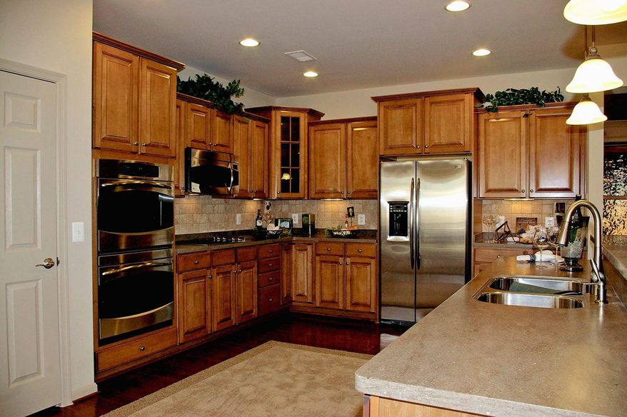 The kitchen in the Berry Hill model has a center island, a pantry and an optional breakfast bar. The kitchen is open to the family room.