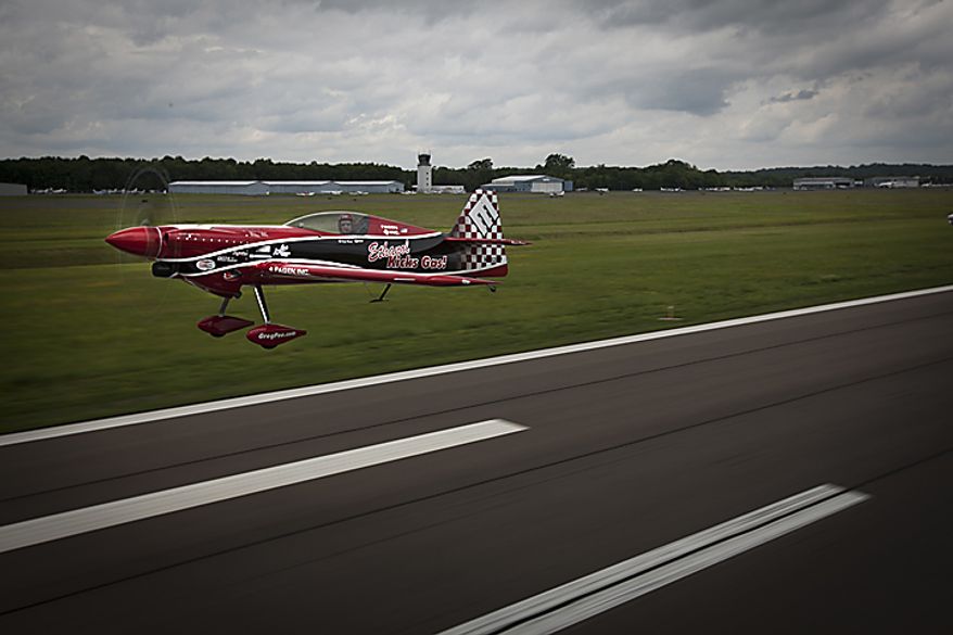Greg Poe takes flight aboard his ethanol powered aircraft, Wednesday, May 18, 2011, in Manassas, Va. Poe will be preforming at the Joint Service Open House and Air Show at Andrews Air force Base, which will also feature the Thunderbirds, the Golden Knights, and other aerial and ground attractions. (Andrew S. Geraci/The Washington Times)
