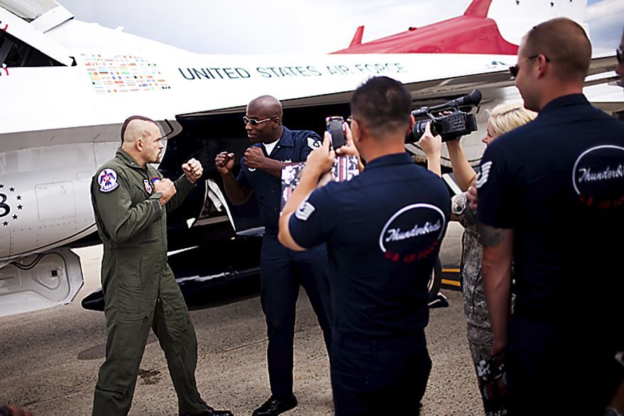 UFC Fighter Chuck Liddell poses for photos with U.S. Air Force Thunderbird crew members, at Andrews Air Force Base, Thursday, May 19, 2011. Liddell got to fly along during their practice session. (Drew Angerer/The Washington Times)