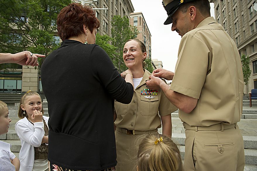 USN PR1 (AW/SW) Amy E. Davis (third from right) gets her pins put on by her mother Carol Chouinard (third from left) and UNS Command Master Chief Stan Kopiczak (right), her son Tristan, 6, (left) daughter Jordan,7,(second from left) and daughter Mackenzie,4,(second from right) during the Sailor of the Year 2010 ceremony at the U.S. Navy Memorial in Washington, D.C., Thursday, May 19, 2011. The Sailor of the Year program began in 1972 to recognize the outstanding Sailors of the Atlantic and Pacific Fleets. (Rod Lamkey Jr./The Washington Times)