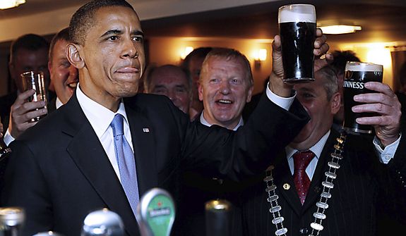 U.S. President Barack Obama drinks Guinness beer as he meets with local residents at Ollie Hayes pub in Moneygall, Ireland, the ancestral homeland of his great-great-great grandfather, Monday, May 23, 2011. (AP Photo/Charles Dharapak)
