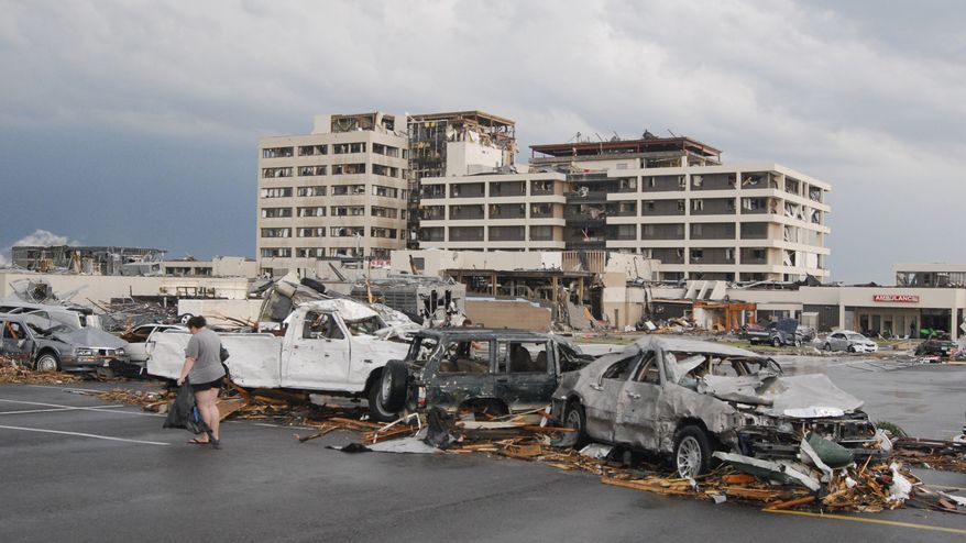Damaged vehicles litter the parking lot of St. John's Regional Medical Center in Joplin, Mo, after a tornado hit the southwest Missouri city on Sunday evening, May 22, 2011. (AP Photo/Mike Gullett)