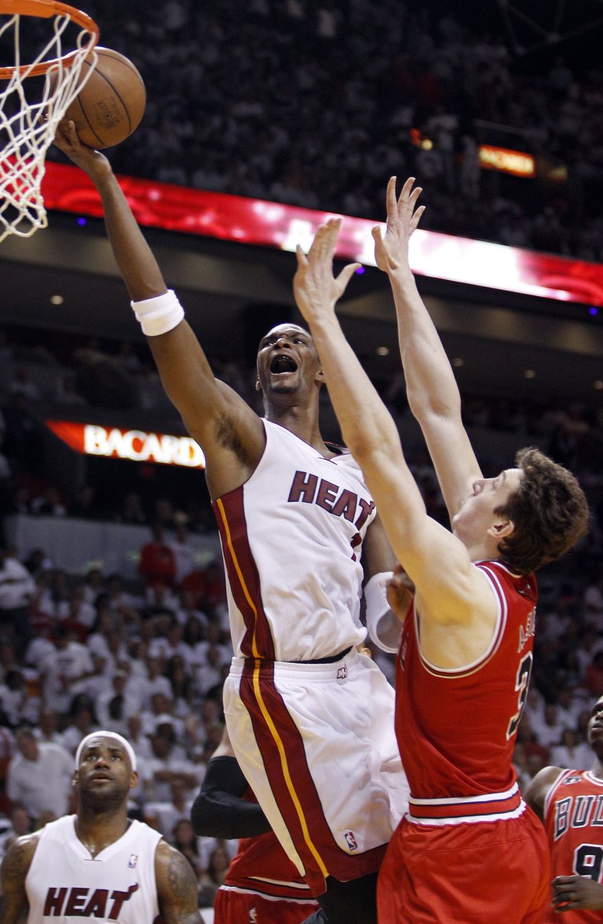 NBA Playoffs: Miami Heat's Chris Bosh goes for a basket over Chicago Bulls' Omer Asik during the first half of Game 4 of the NBA Eastern Conference finals basketball series in Miami, Tuesday, May 24, 2011. (AP Photo/Lynne Sladky)