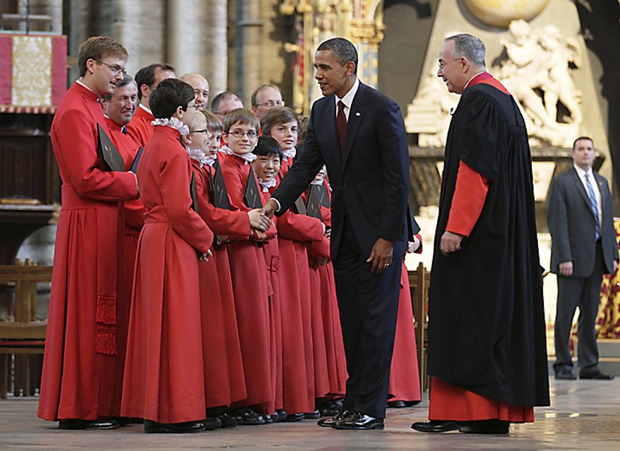 President Obama, accompanied by the Very Rev. John Hall (second from right), the dean of Westminster Abbey, shakes hands with members of the historic church's choir during a visit to London on Tuesday, May 24, 2011. (AP Photo/Carolyn Kaster)
