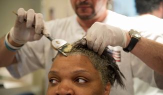 Alexis Carter gets her hair colored at Piaf Salon. A bill to be reintroduced by Rep. Janice D. Schakowsky would give the FDA more regulatory control over beauty products. Many salon workers favor the bill but not manufacturers. (Barbara L. Salisbury/The Washington Times)