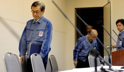 Tokyo Electric Power Co. President Masataka Shimizu arrives for a news conference at company headquarters in Tokyo on Friday to announce that he is stepping down. (Associated Press)