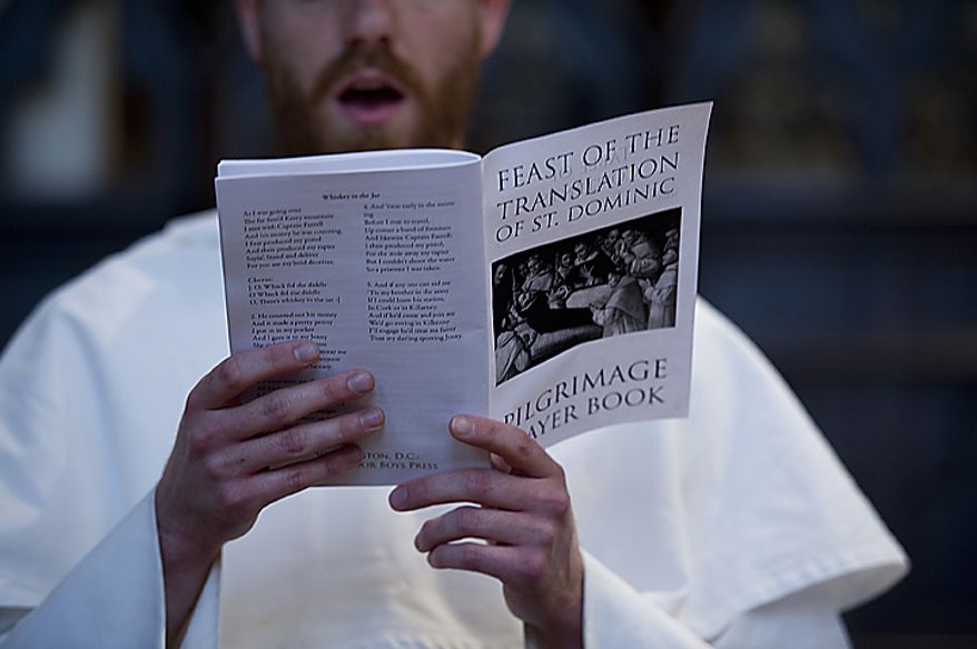 A Catholic friar of the Dominican order sings hymns from the pilgrimage prayer book before he and 13 other friars headed out on a pilgrimage on Tuesday, May 24, 2011, from the Dominican House of Studies in Northeast Washington to St. Dominic's Parish in Southwest. This is the first time the friars have held the pilgrimage, which commemorated the date that St. Dominic's body was moved from its original grave to its current resting place in Bologna, Italy. Each of the friars was instructed to have a personal intention for the pilgrimage. (Barbara L. Salisbury/The Washington Times)