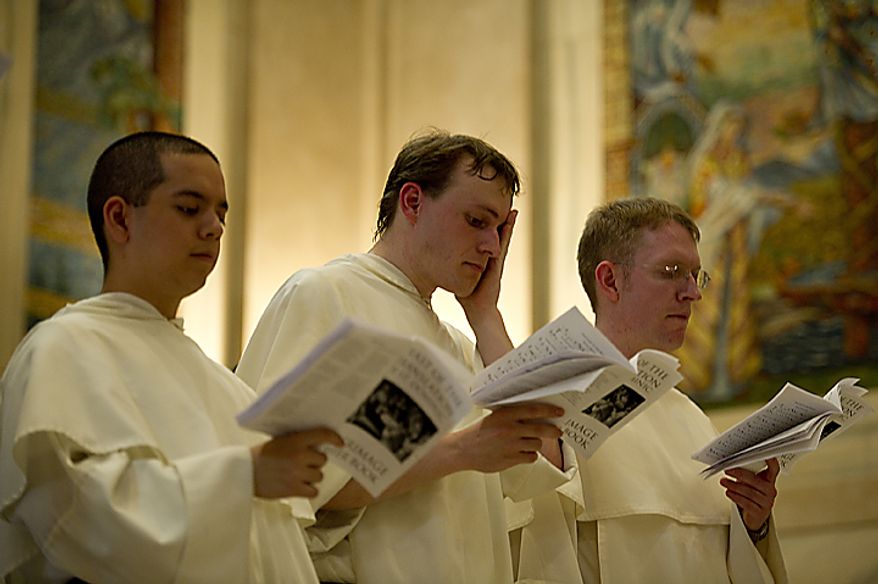 Brother John Baptist Hoang (left), Brother Philip Neri Reese (center) and Father James Brent sing from their pilgrimage hymnal during a stop at the Cathedral of St. Matthew the Apostle in downtown Washington on Tuesday, May 24, 2011. Fourteen Catholic friars from the Dominican order held a pilgrimage from the Dominican House of Studies in Northeast Washington to St. Dominic's Parish in Southwest. This is the first time the friars have held the pilgrimage, which commemorated the date that St. Dominic's body was moved from its original grave to its current resting place in Bologna, Italy. Each of the friars was instructed to have a personal intention for the pilgrimage. (Barbara L. Salisbury/The Washington Times)