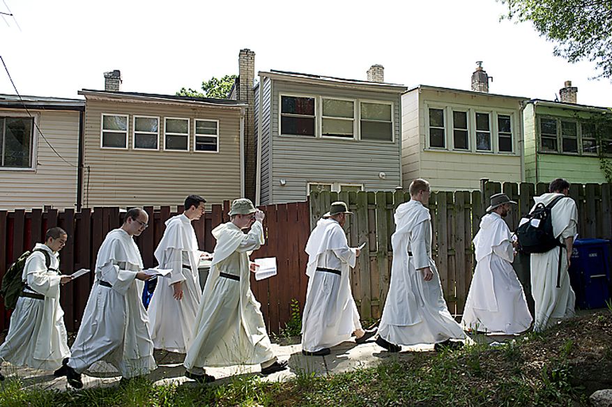 Catholic friars from the Dominican order walk down a residential street in Northeast Washington on Tuesday, May 24, 2011, on a pilgrimage from the Dominican House of Studies in Northeast to St. Dominic's Parish in Southwest. The walk was to commemorate the date that St. Dominic's body was moved from its original grave to its current resting place in Bologna, Italy. Each of the friars was instructed to have a personal intent for the pilgrimage, and along the way they sang hymns and said prayers. (Barbara L. Salisbury/The Washington Times)