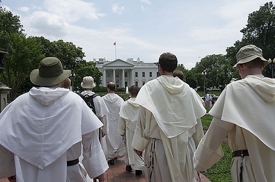 Catholic friars from the Dominican order walk past the White House in Washington on Tuesday, May 24, 2011, on their pilgrimage from the Dominican House of Studies in Northeast Washington to St. Dominic's Parish in Southwest. This is the first time the friars have held the pilgrimage, which commemorated the date that St. Dominic's body was moved from its original grave to its current resting place in Bologna, Italy. (Barbara L. Salisbury/The Washington Times)