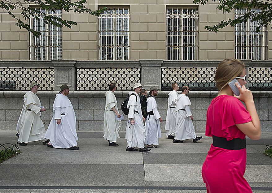 Catholic friars from the Dominican order walk through Lafayette Park in Washington on Tuesday, May 24, 2011, on their pilgrimage from the Dominican House of Studies in Northeast Washington to St. Dominic's Parish in Southwest. This is the first time the friars have held the pilgrimage, which commemorated the date that St. Dominic's body was moved from its original grave to its current resting place in Bologna, Italy. (Barbara L. Salisbury/The Washington Times)