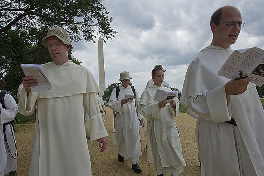 Catholic friars from the Dominican order sing hymns and say prayers as they walk along the National Mall in Washington on Tuesday, May 24, 2011, on their pilgrimage from the Dominican House of Studies in Northeast Washington to St. Dominic's Parish in Southwest. This is the first time the friars have held the pilgrimage, which commemorated the date that St. Dominic's body was moved from its original grave to its current resting place in Bologna, Italy. (Barbara L. Salisbury/The Washington Times)