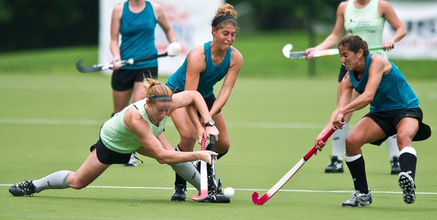 Maxine Fluharty (#2, center) and Dina Rizzo (#12, right) of Mid Atlantic put the pressure on as Claire Llaubach (#21, left) of Pennsylvania falls to the ground in the second half during the USA Field Hockey Women's National Championship at American University on May 20, 2011. Pennsylvania went on to win 1-0. (Rod Lamkey Jr./The Washington Times)