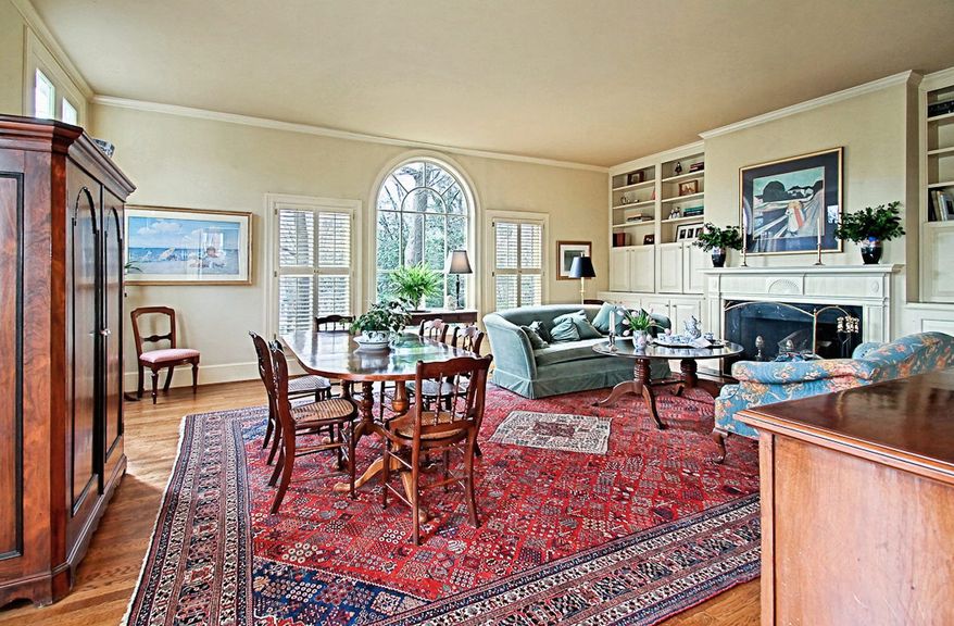The great room is the home's main gathering place. There's space enough for a dining table, as well as seating areas to enjoy the wood-burning fireplace.