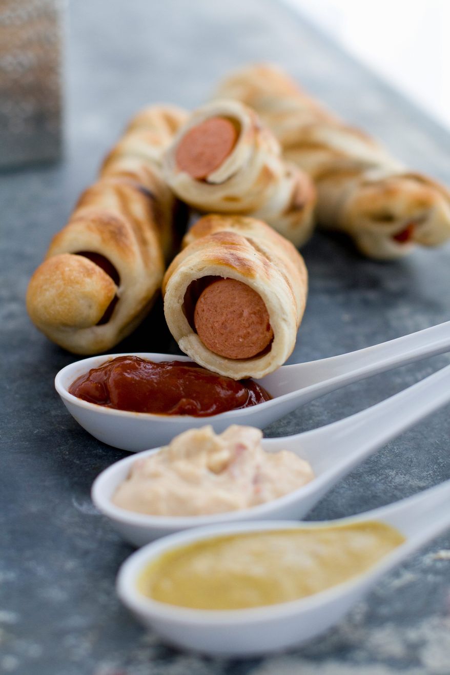 ASSOCIATED PRESS
Instead of grilling hot dogs and serving them on buns, try wrapping pizza dough "buns" around the hot dogs and then grilling them. These hot dogs are perfect for dipping in different types of special sauces.