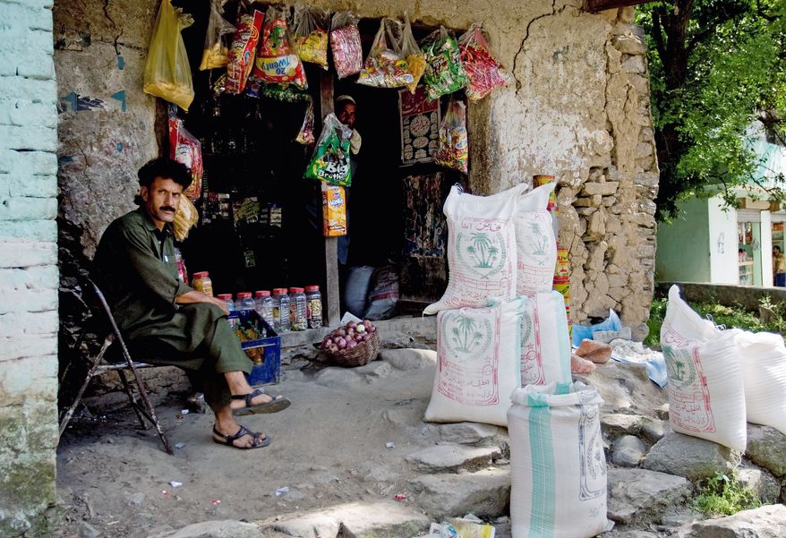 ASSOCIATED PRESS
This Pakistani shopkeeper awaits customers in Guli Badral, where locals say men whom they presume to be soldiers shop for meat, flour and beans before getting into pickup trucks for a two-hour trip along a rough track to their mountain training camp.