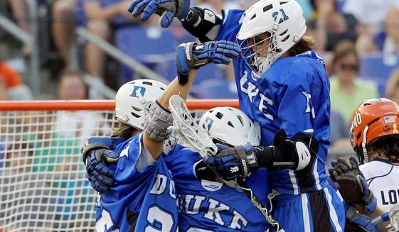 Duke University lacrosse players celebrate a goal in a semifinal game in Baltimore in this 2011 file photo (Associated Press) ** FILE **