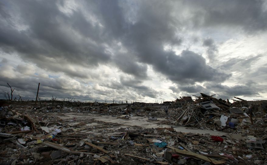 Storm clouds pass over the devastated Greenbriar Nursing Home in Joplin, Mo. on Wednesday, May 25, 2011. Eleven residents of the facility died when an EF-5 tornado tore through much of the city Sunday, damaging a hospital and hundreds of homes and businesses and killing at least 125 people. (AP Photo/Charlie Riedel)