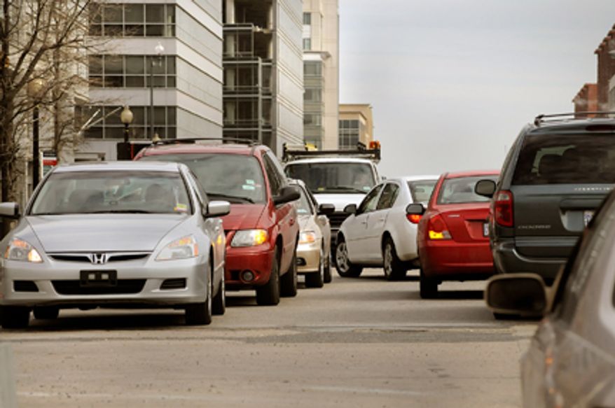 **FILE** Cars back up in both directions waiting to make left hand turns from M Street onto South Capitol Street in Southeast. (The Washington Times)