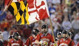 NCAA lacrosse: Maryland&#39;s Mark White runs with the state flag after defeating Duke 9-4 in the NCAA college men&#39;s Division I lacrosse semifinal game. (AP Photo/Gail Burton)