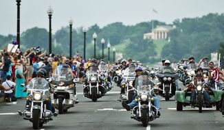 Bikers in the Rolling Thunder motorcycle rally ride across Memorial Bridge on Sunday. The 24th annual event, which saw thousands of military and civilian motorcycle riders rumble across the District, was held to remember American prisoners of war and support veterans. (Drew Angerer/The Washington Times)