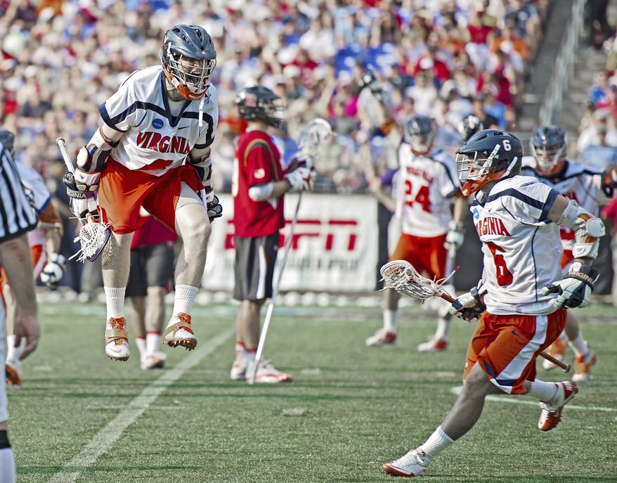 Virginia's Matt White (above) goes airborne as he celebrates one of his goals with Steele Stanwick (6) in the fourth quarter. White scored three times as the Cavaliers defeated Maryland 9-7 to win the NCAA Division I lacrosse championship. Maryland's Grant Catalino (below right) found himself squeezed. (Rod Lamkey Jr./The Washington Times)