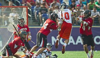 Ryder Bohlander (34) and Dan Burns (4) of the Maryland Terrapins defend against Chris Bocklet (10) of the Virginia Cavaliers during the NCAA Division I lacrosse championship in Baltimore on Monday, May 30, 2011. (Rod Lamkey Jr./The Washington Times)