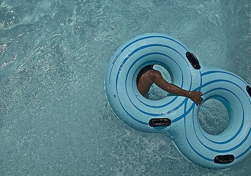 A boy ducks under an innertube at the Lazy River at the Water Mine Family Swimmin' Hole at Lake Fairfax in Reston, Va., on Monday, May 30, 2011. The water park was filled to capacity on a very hot Memorial Day. (Barbara L. Salisbury/The Washington Times)