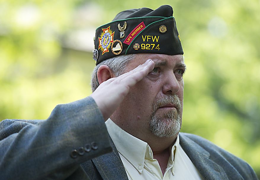 Bob Smith, who served in Vietnam and is the immediate past commander of VFW Post 9274, salutes during the Memorial Day Veteran's Ceremony at the annual Falls Church City Memorial Day Parade & Festival on Monday, May 30, 2011. "Don't just remember our troops on Memorial Day and Veteran's Day," Smith, the keynote speaker for the ceremony, told the audience. "Honor them every day." (Barbara L. Salisbury/The Washington Times)