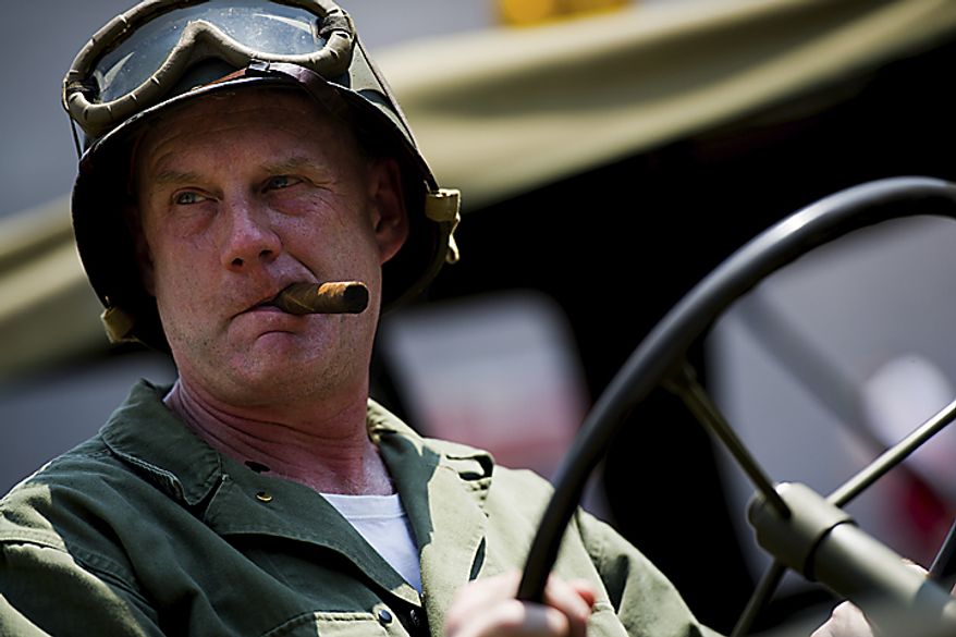 Waiting for the National Memorial Day Parade to start, Dan LeFevre sits in his World War II era jeep that he spent three years restoring, in Washington, D.C., Monday, May 30, 2011. LeFevre collects World War II era uniforms and attire from the war. (Drew Angerer/The Washington Times)