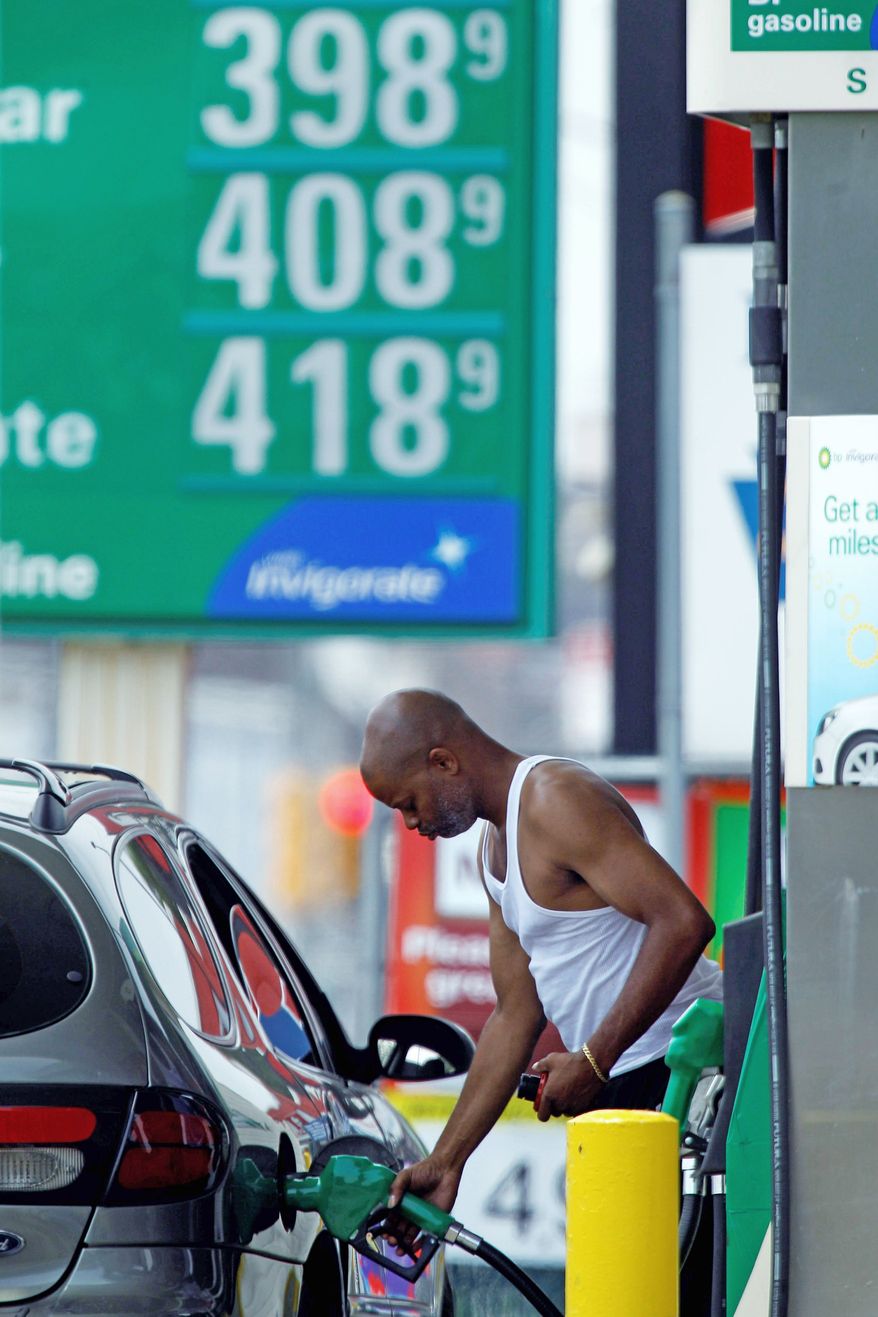 A customer fuels up his car in view of gas prices on Friday in Philadelphia. A survey shows consumers are losing faith that the economy will keep improving. Factors include high gas prices and a moribund housing market. (Associated Press)