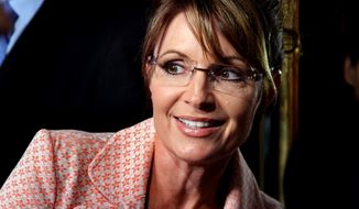 Former governor of Alaska Sarah Palin looks back at a crowd as she walks to the door of Trump Tower for a scheduled meeting with Donald Trump in New York Tuesday, May 31, 2011. (AP Photo/Craig Ruttle/File)