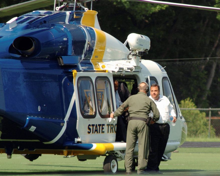 New Jersey Gov. Chris Christie exits a state helicopter to attend his son's high school baseball game in Montvale, N.J., on Tuesday, May 31, 2011. State police say it costs $2,500 an hour to fly a state helicopter but that flying Mr. Christie to his son's game didn't cost taxpayers anything extra. (Patch.com via Associated Press)