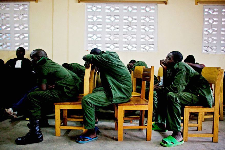 ASSOCIATED PRESS PHOTOGRAPHS
Soldiers accused of rape and crimes against humanity sit through a military tribunal in the town of Baraka, Congo. A Congolese court sentenced an army colonel to 20 years in prison in the highest-profile sexual violence case ever tried in this nation, where thousands are brutally raped each year. The February trial held in a torridly hot makeshift courtroom marks the first time a commanding officer has been tried for such a crime.