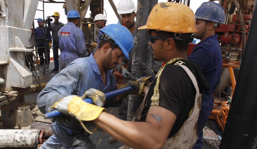 Oil workers work at Zubair oil field near Basra, 340 miles southeast of Baghdad, Iraq, Sunday, May 15, 2011. (AP Photo/Nabil al-Jourani) ** FILE **