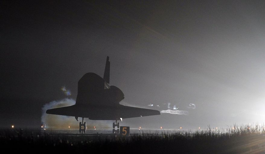 The space shuttle Endeavour touches down on Runway 15 at the Kennedy Space Center at Cape Canaveral, Fla., on Wednesday, June 1, 2011, after completing her final flight. Endeavour and her crew of six astronauts wrapped up a 16-day mission to the International Space Station. (AP Photo/John Raoux)