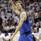 Dallas Mavericks&#x27; Dirk Nowitzki pumps his fist at the end of the second half of Game 2 of the NBA finals against the Miami Heat. The Mavericks defeated the Heat 95-93 on Nowitzki&#x27;s game-winning layup. (AP Photo/David J. Phillip)