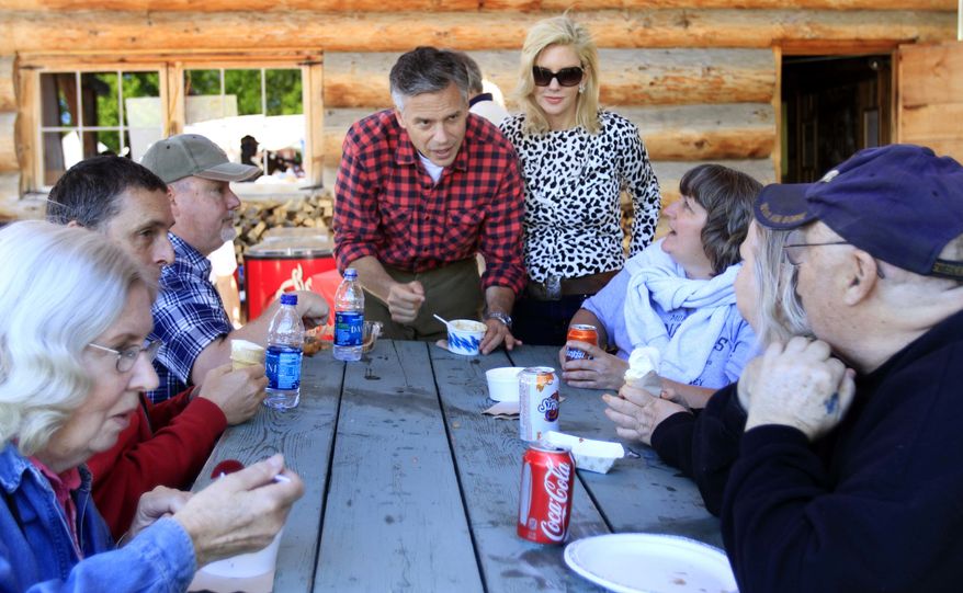 With his wife Mary Kaye at his side possible 2012 presidential hopeful, former Republican Gov. Jon Huntsman Jr. of Utah talks to Edward Bergeron during a cultural festival at Heritage Park, Saturday, June 4, 2011, in Berlin, N.H. (AP Photo/Jim Cole)