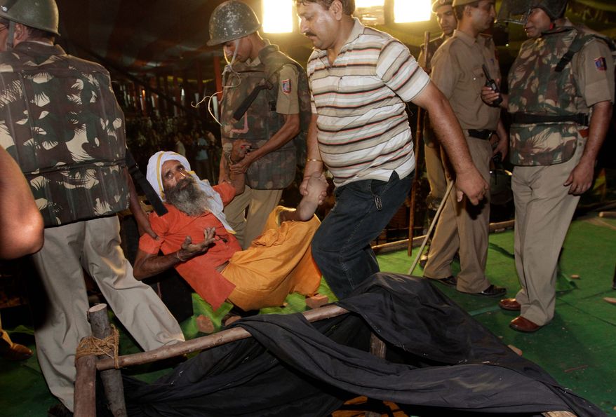 ASSOCIATED PRESS
Indian police officers remove a supporter of yoga guru Baba Ramdev's hunger strike Sunday. Mr. Ramdev, who has millions of followers across India on a daily television show, is demanding an end to endemic corruption.