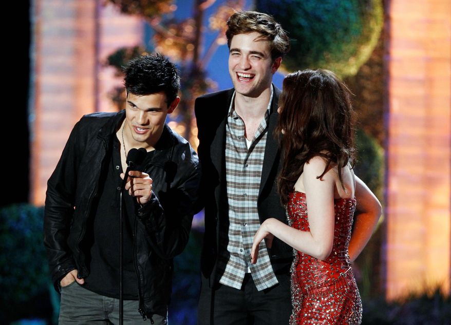Taylor Lautner (left), Robert Pattinson and Kristen Stewart of "The Twilight Saga: Eclipse" share the stage at the MTV Movie Awards. (Associated Press)